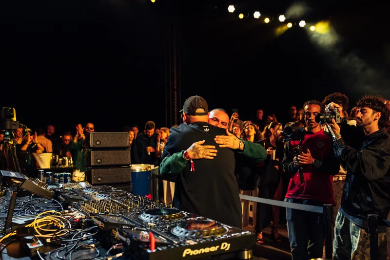 Artists embracing behind the decks during the night set