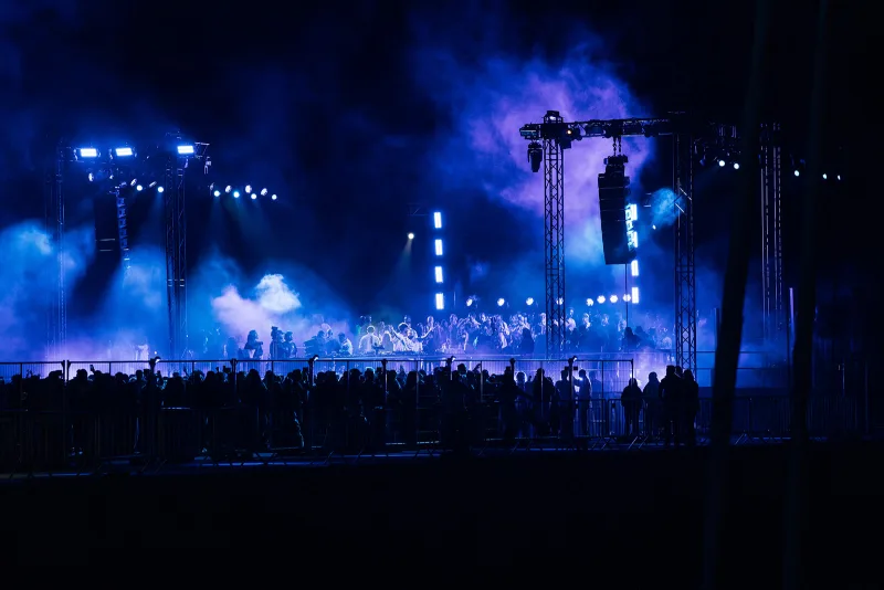 Night stage immersed in blue light and atmospheric smoke
